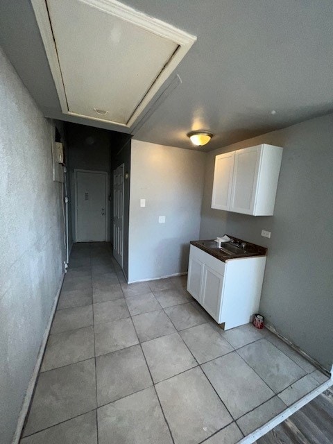 12256 S Union Ave, Chicago, IL 60628 - kitchen with white cabinets, light tile patterned flooring, and dark countertops