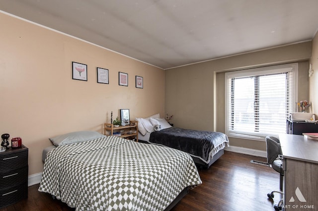 bedroom with dark wood-style flooring, crown molding, baseboards, and a desk