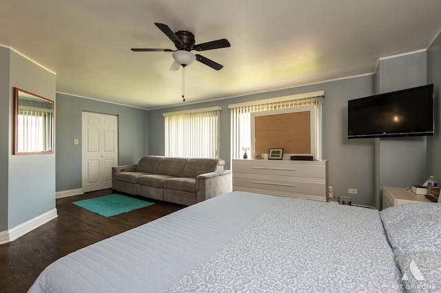 bedroom with baseboards, wood finished floors, and a ceiling fan