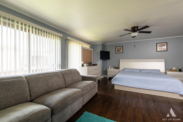 bedroom with wood finished floors, crown molding, and ceiling fan