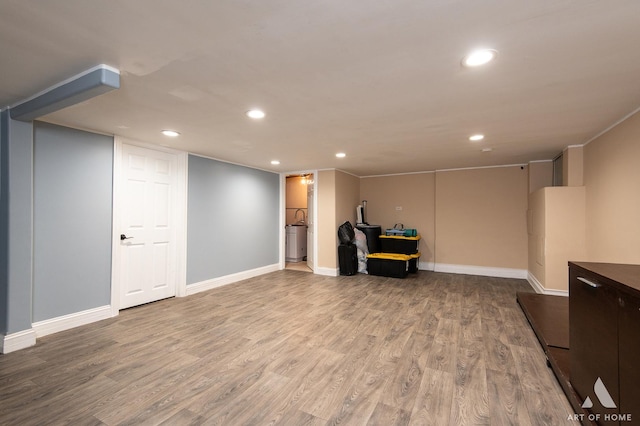 finished basement with recessed lighting, wood finished floors, and baseboards