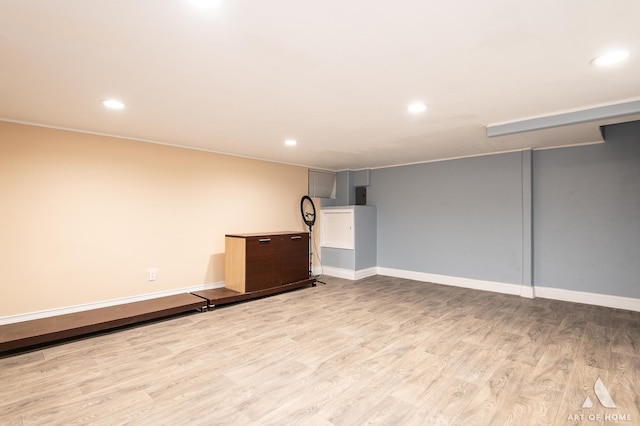 finished basement featuring wood finished floors, recessed lighting, and baseboards