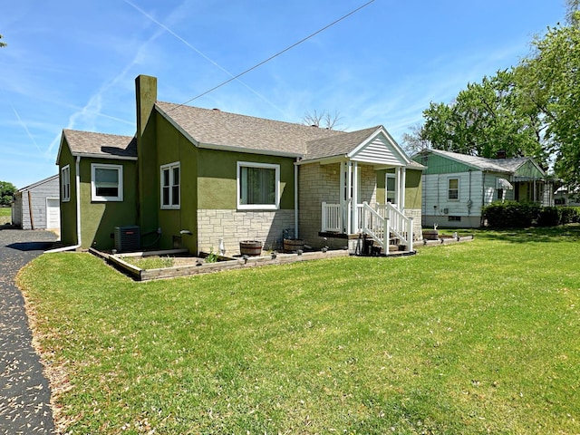 925 N Otter Creek Rd, Streator, IL 61364 - view of front of home featuring stone siding, central AC unit, a front yard, and roof with shingles