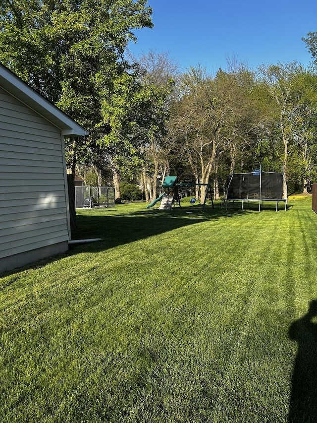 795 N Erie St, Braidwood, IL 60408 - view of green lawn with a trampoline and a playground