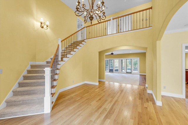 4410 Southford Trace Dr, Champaign, IL 61822 - entryway with arched walkways, stairway, wood finished floors, baseboards, and a high ceiling