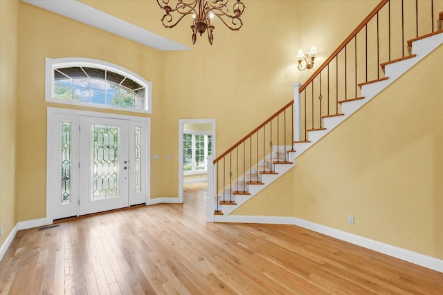 4410 Southford Trace Dr, Champaign, IL 61822 - entrance foyer with a chandelier, stairway, hardwood / wood-style floors, baseboards, and a high ceiling