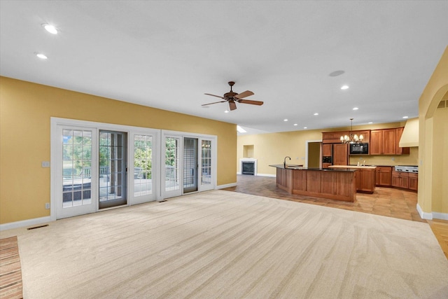 4410 Southford Trace Dr, Champaign, IL 61822 - unfurnished living room with baseboards, a sink, a chandelier, recessed lighting, and a ceiling fan