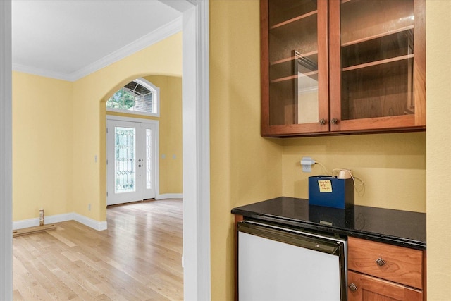 4410 Southford Trace Dr, Champaign, IL 61822 - bar with crown molding, light wood-type flooring, arched walkways, and baseboards