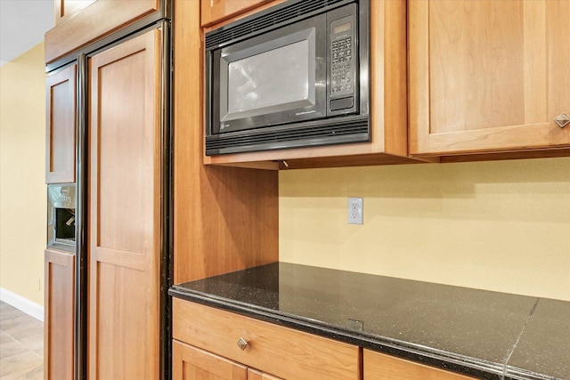 4410 Southford Trace Dr, Champaign, IL 61822 - kitchen with built in appliances, light brown cabinetry, dark stone counters, and baseboards
