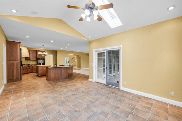 4410 Southford Trace Dr, Champaign, IL 61822 - kitchen with arched walkways, a ceiling fan, open floor plan, vaulted ceiling, and a center island