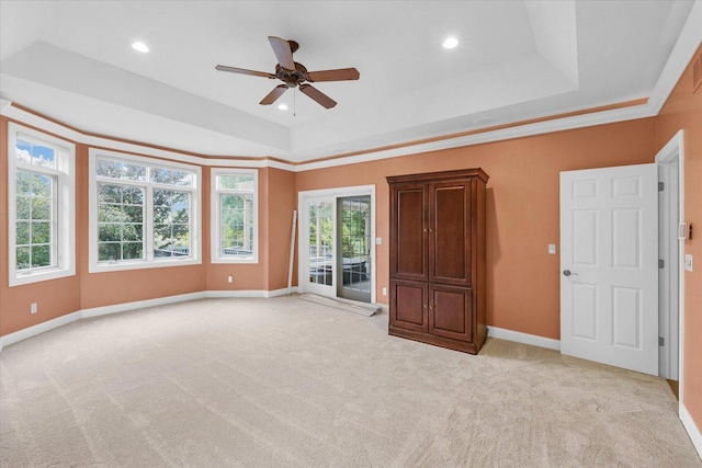 4410 Southford Trace Dr, Champaign, IL 61822 - unfurnished room featuring a tray ceiling, ceiling fan, light colored carpet, plenty of natural light, and recessed lighting