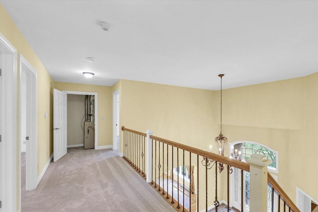 4410 Southford Trace Dr, Champaign, IL 61822 - hallway with an upstairs landing, a chandelier, carpet, and baseboards