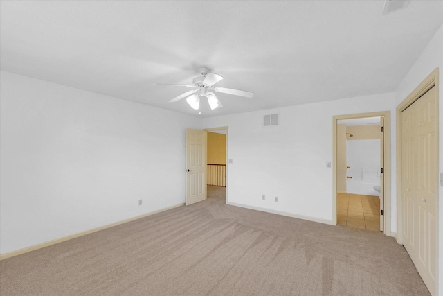 4410 Southford Trace Dr, Champaign, IL 61822 - unfurnished bedroom with light carpet, baseboards, ceiling fan, and connected bathroom