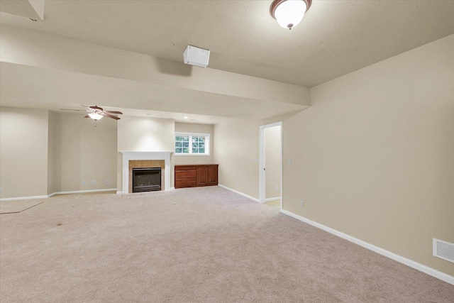 4410 Southford Trace Dr, Champaign, IL 61822 - unfurnished living room with baseboards, a glass covered fireplace, light colored carpet, and ceiling fan
