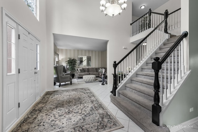 9 Laurel Valley Ct, Lake In The Hills, IL 60156 - tiled foyer with a towering ceiling, stairs, and a chandelier