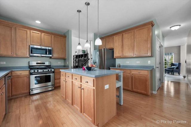 9 Laurel Valley Ct, Lake In The Hills, IL 60156 - kitchen with appliances with stainless steel finishes, light wood-type flooring, hanging light fixtures, a kitchen island, and recessed lighting