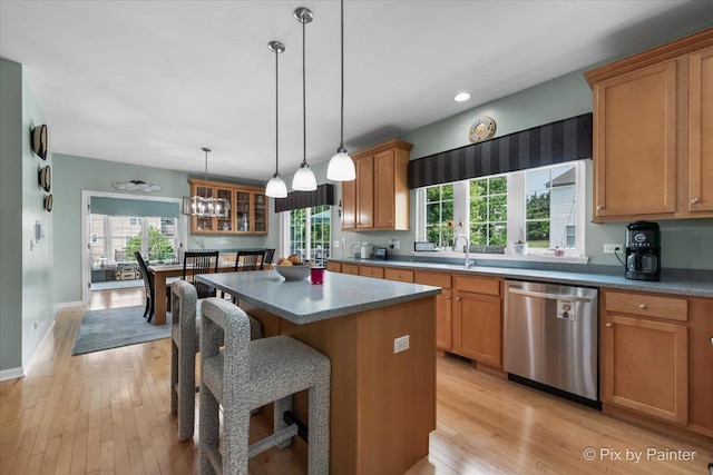 9 Laurel Valley Ct, Lake In The Hills, IL 60156 - kitchen with dishwasher, light wood finished floors, a kitchen bar, a kitchen island, and glass insert cabinets