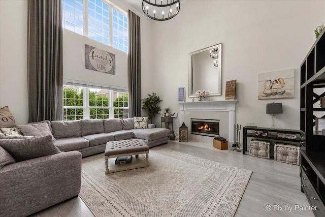 9 Laurel Valley Ct, Lake In The Hills, IL 60156 - living area featuring a high ceiling, a chandelier, a fireplace, and wood finished floors
