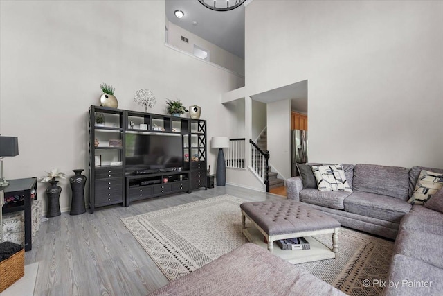 9 Laurel Valley Ct, Lake In The Hills, IL 60156 - living room featuring wood finished floors, stairway, and a towering ceiling