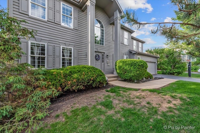 9 Laurel Valley Ct, Lake In The Hills, IL 60156 - view of exterior entry with an attached garage and a lawn