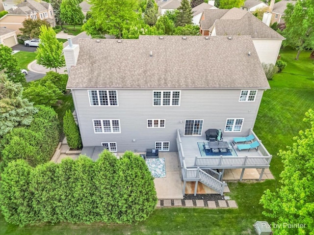 9 Laurel Valley Ct, Lake In The Hills, IL 60156 - back of property with a wooden deck, a yard, roof with shingles, and a chimney