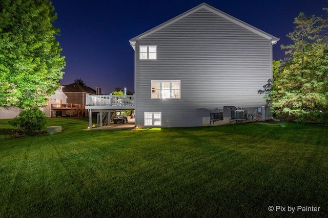 9 Laurel Valley Ct, Lake In The Hills, IL 60156 - property exterior at twilight with a wooden deck and a lawn