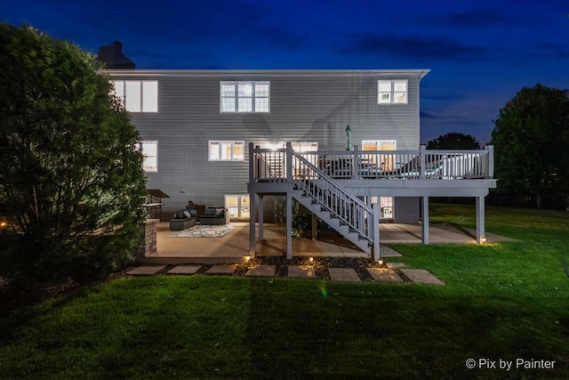 9 Laurel Valley Ct, Lake In The Hills, IL 60156 - back of house at twilight with a patio, stairway, a deck, and a lawn