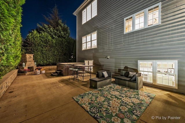 9 Laurel Valley Ct, Lake In The Hills, IL 60156 - patio at twilight featuring a hot tub, a patio area, and an outdoor living space with a fireplace