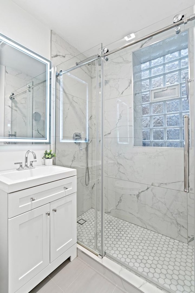 532 W Belmont Ave Unit 2N, Chicago, IL 60657 - full bath featuring a marble finish shower, vanity, and tile patterned flooring