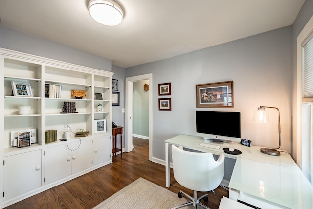 office space with dark wood-type flooring and baseboards