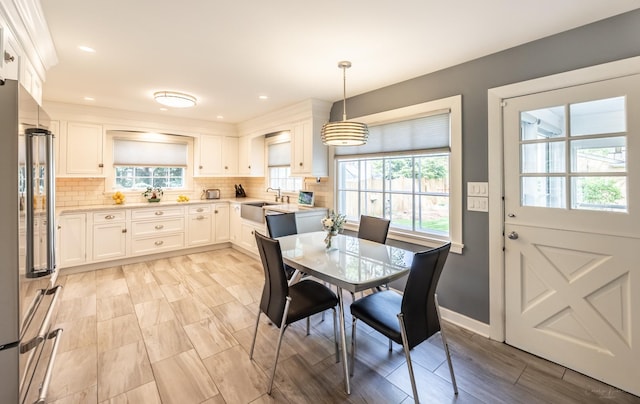 dining space with healthy amount of natural light, baseboards, and recessed lighting