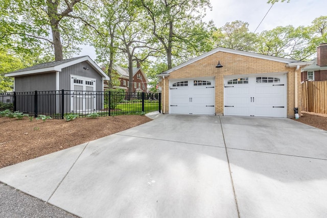 detached garage featuring fence