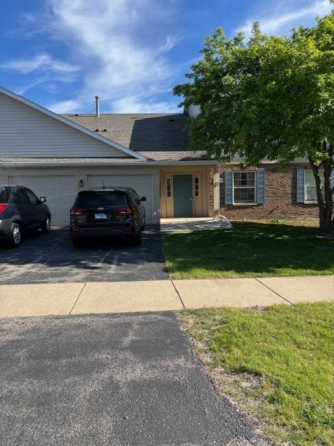 1286 N Red Oak Cir Unit 4, Round Lake Beach, IL 60073 - ranch-style house featuring asphalt driveway, an attached garage, a front lawn, brick siding, and roof with shingles