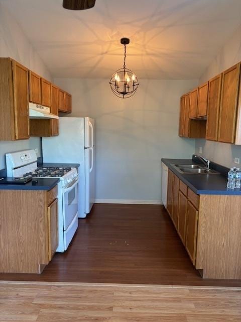 1286 N Red Oak Cir Unit 4, Round Lake Beach, IL 60073 - kitchen with white range with gas cooktop, a sink, dark countertops, baseboards, and wood finished floors