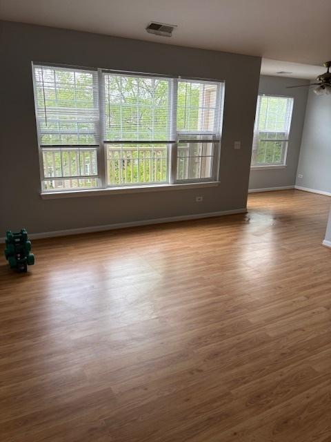 1286 N Red Oak Cir Unit 4, Round Lake Beach, IL 60073 - unfurnished room with wood finished floors, baseboards, and ceiling fan