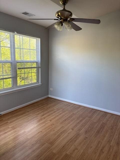 1286 N Red Oak Cir Unit 4, Round Lake Beach, IL 60073 - empty room with baseboards, wood finished floors, and a ceiling fan