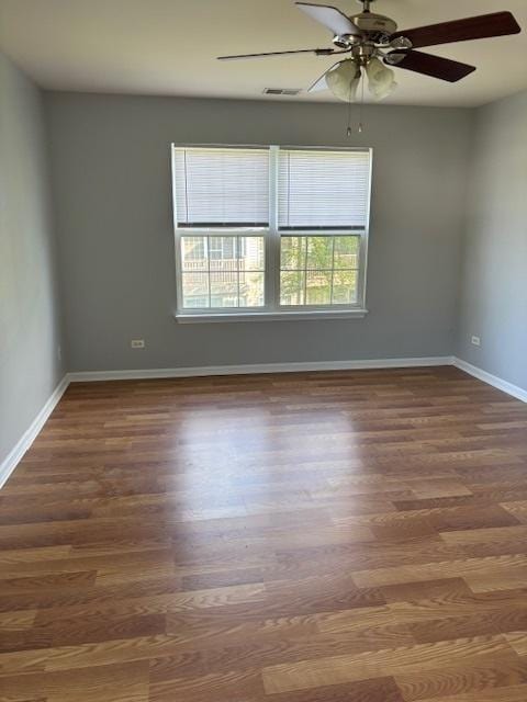 1286 N Red Oak Cir Unit 4, Round Lake Beach, IL 60073 - unfurnished room featuring wood finished floors, baseboards, and ceiling fan