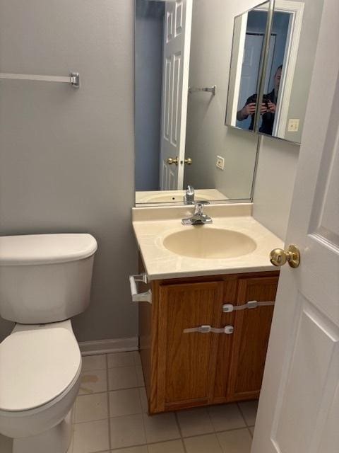 1286 N Red Oak Cir Unit 4, Round Lake Beach, IL 60073 - half bathroom with vanity, toilet, tile patterned flooring, and baseboards