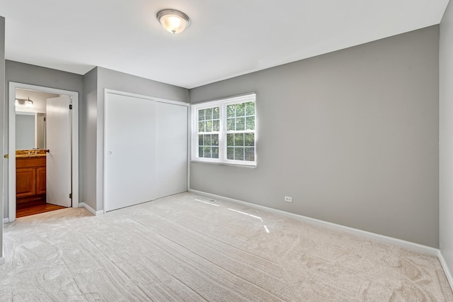 1400 Carleton Ave, Naperville, IL 60565 - unfurnished bedroom featuring carpet flooring, a closet, baseboards, and connected bathroom