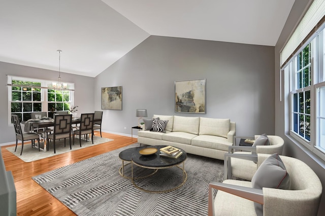 1400 Carleton Ave, Naperville, IL 60565 - living area with a chandelier, light wood-style floors, baseboards, and high vaulted ceiling