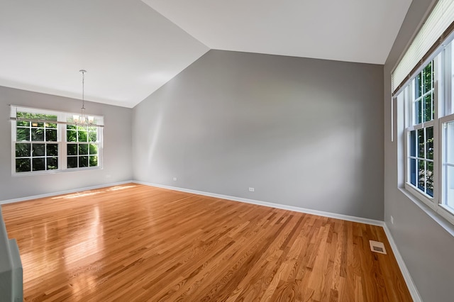 1400 Carleton Ave, Naperville, IL 60565 - unfurnished room with vaulted ceiling, a chandelier, light wood-style flooring, and baseboards