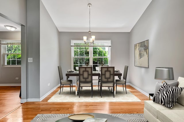 1400 Carleton Ave, Naperville, IL 60565 - dining room featuring light wood-style flooring, a chandelier, healthy amount of natural light, and baseboards