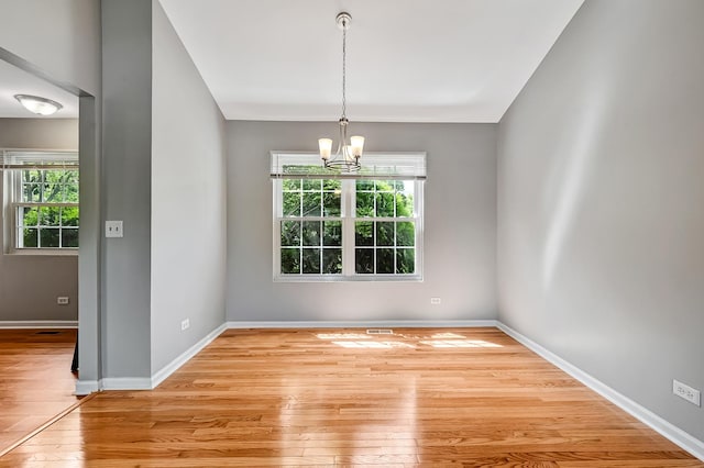 1400 Carleton Ave, Naperville, IL 60565 - spare room with hardwood / wood-style floors, a chandelier, plenty of natural light, and baseboards