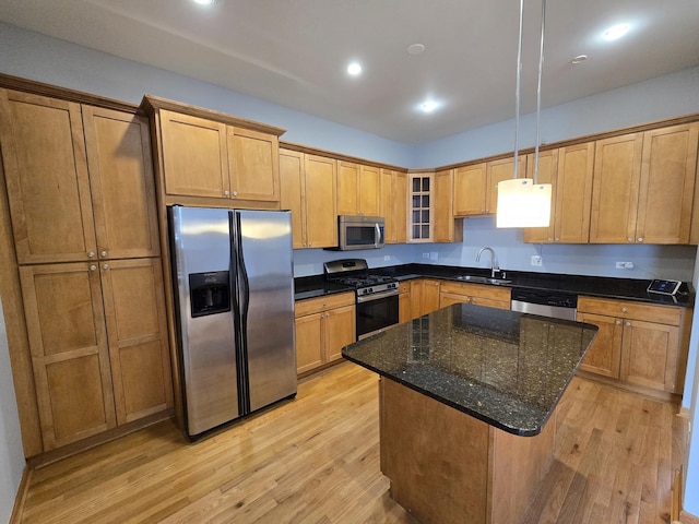 6137 S Kimbark Ave Unit 1, Chicago, IL 60637 - kitchen with appliances with stainless steel finishes, a sink, light wood-style floors, glass insert cabinets, and a center island