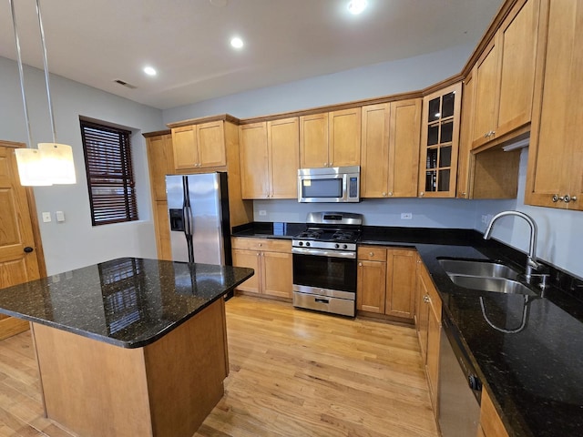 6137 S Kimbark Ave Unit 1, Chicago, IL 60637 - kitchen with stainless steel appliances, a sink, light wood finished floors, glass insert cabinets, and recessed lighting