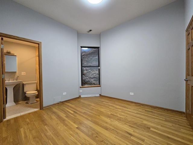 6137 S Kimbark Ave Unit 1, Chicago, IL 60637 - unfurnished bedroom featuring light wood-style floors, ensuite bathroom, and baseboards