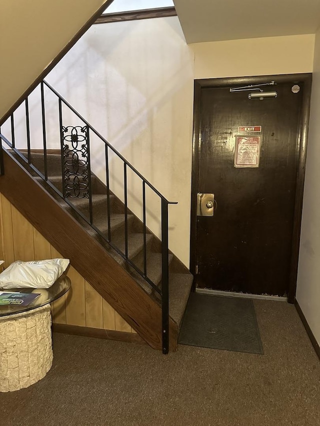 stairway with carpet flooring and baseboards