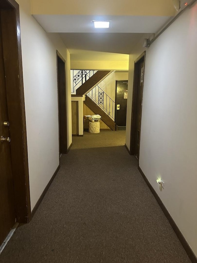 hallway with baseboards, stairway, and carpet