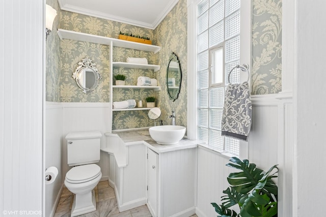 1022 Elmwood Ave, Evanston, IL 60202 - bathroom with toilet, wallpapered walls, healthy amount of natural light, a wainscoted wall, and crown molding