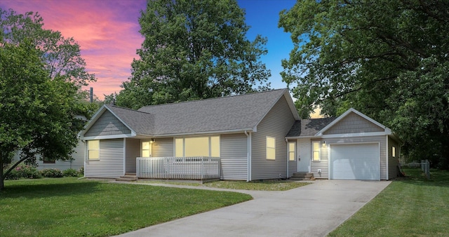 106 W Dunbar St, Mahomet, IL 61853 - view of front of house featuring concrete driveway, an attached garage, roof with shingles, and a lawn